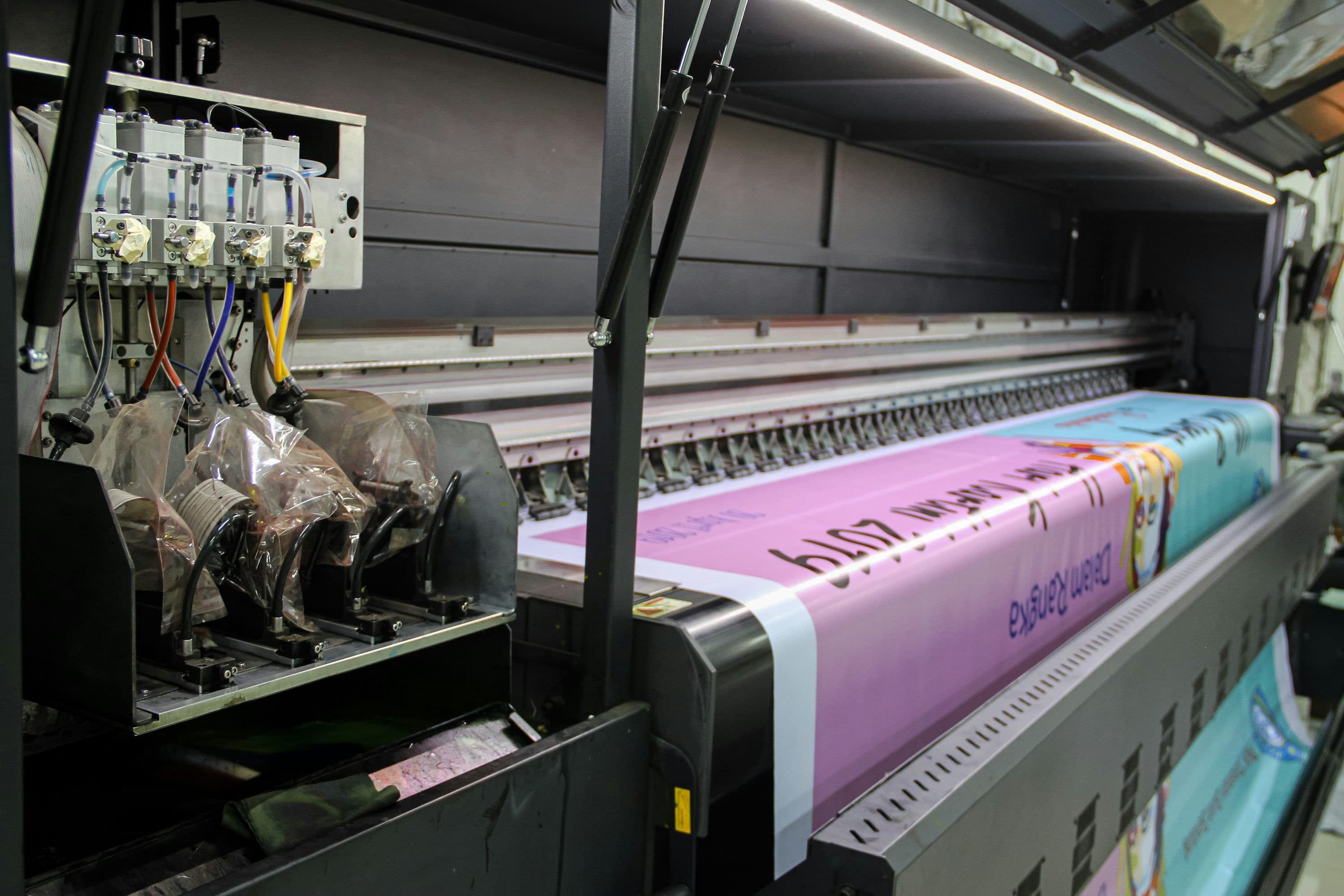 Large-format printer producing a trade show graphic in a production shop