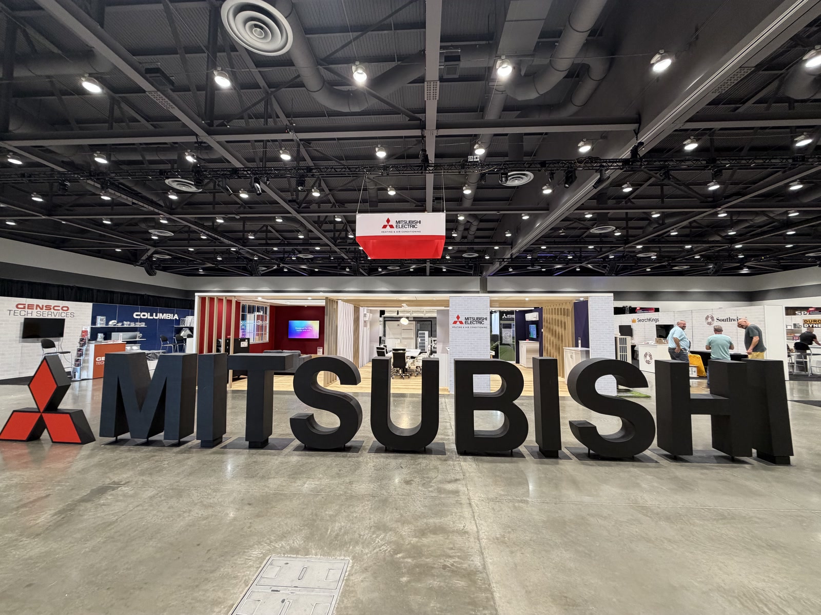 Dimensional Mitsubishi letters in front of Mitsubishi Electric HVAC trade show booth.